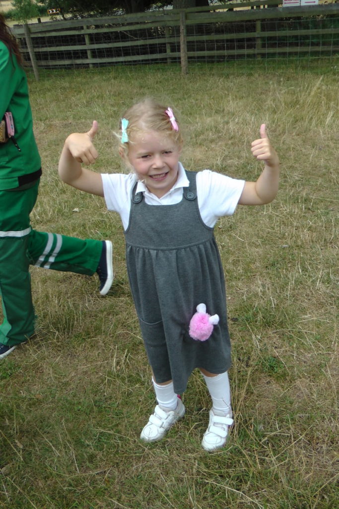 little girl with thumbs up